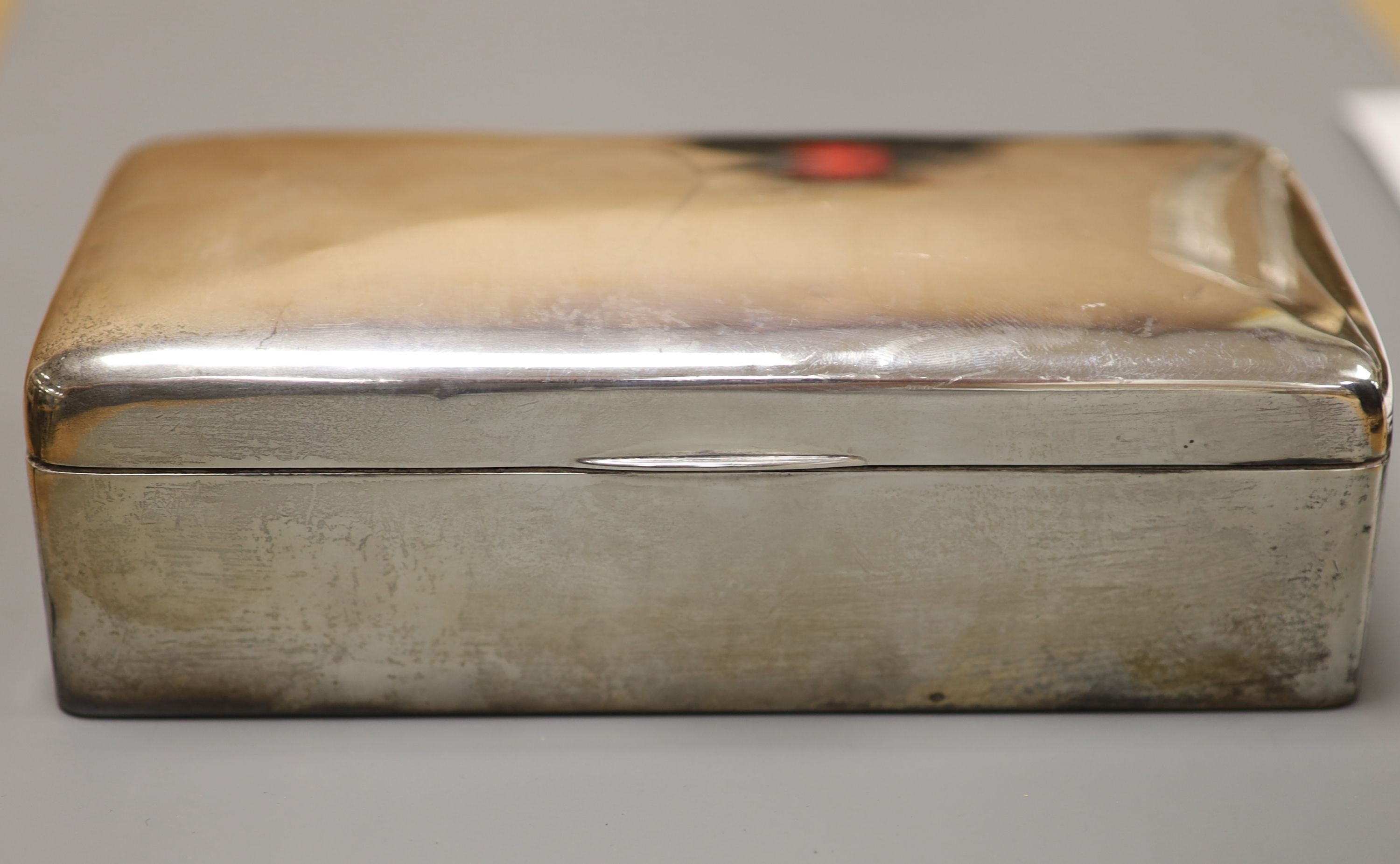 Three silver mounted cigarette cases, largest 17.9cm.